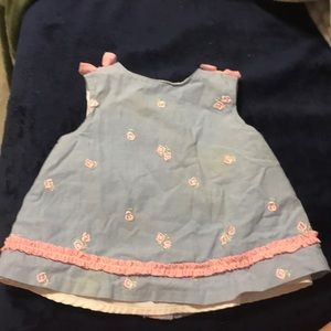 Embroidered flowers  ruffles at the bottom to the bows on the sleeves
